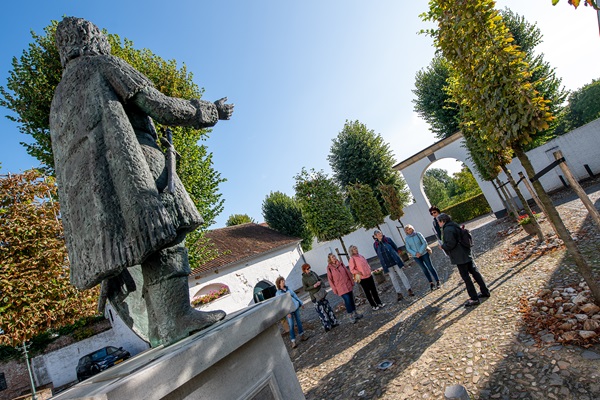 Gids vertelt over een standbeeld aan een groep die de rondleiding door Thorn volgt